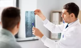 doctor showing patient x-ray image