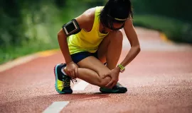 athlete holding injured leg