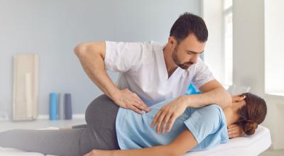 therapist helping patient with flexibility